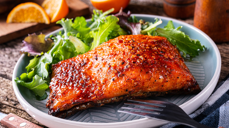 Seasoned cooked salmon served on plate