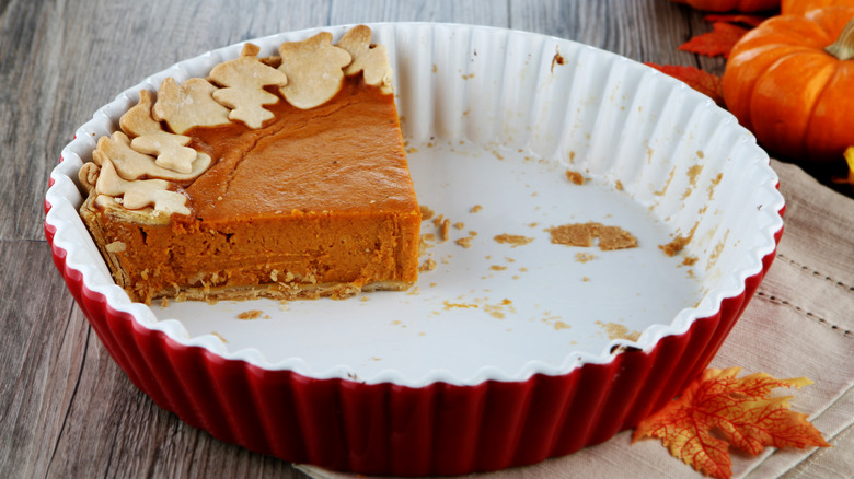A lone slice of pumpkin pie sits in its pie dish
