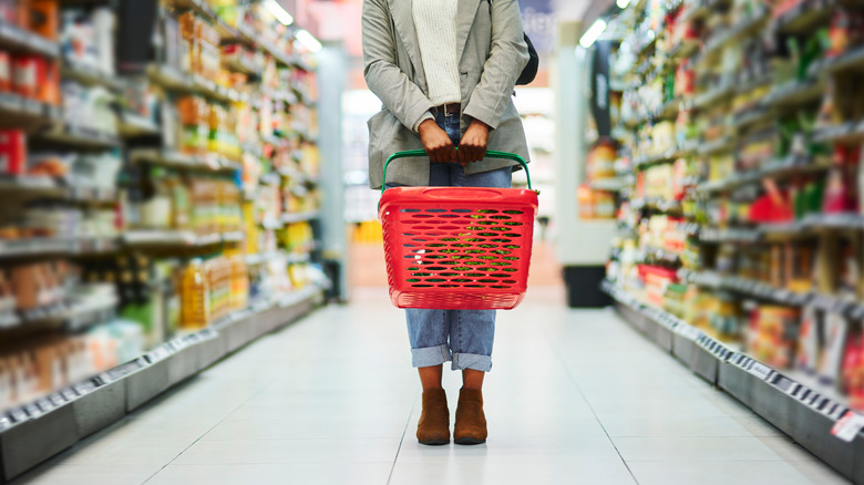 Woman standing in grocery store aisle