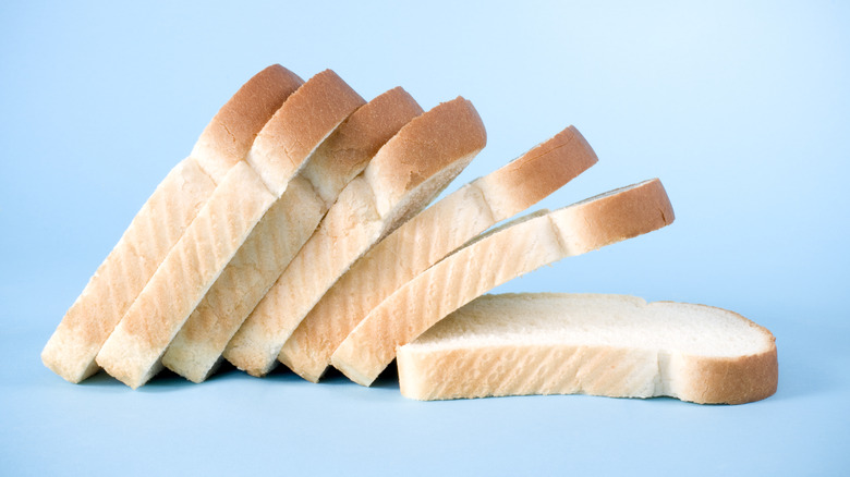 Slices of white bread on blue background