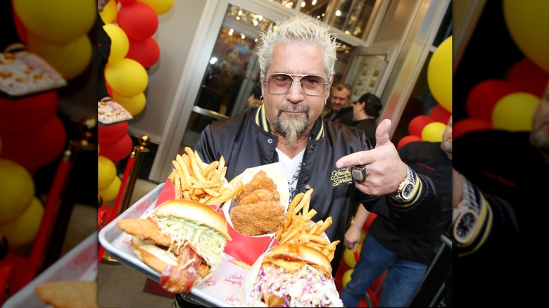 Guy Fieri points to his Chicken Guy! food on a tray
