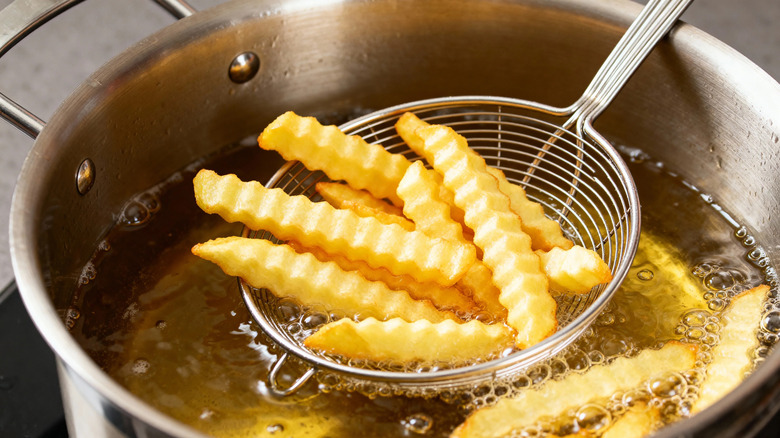 Fries cooking in oil.