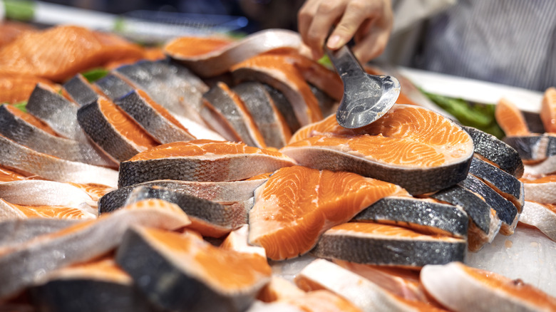 Salmon steaks are on display over ice.