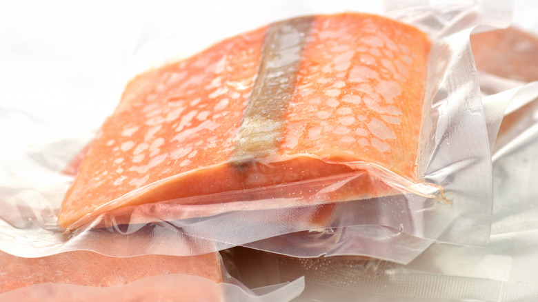Frozen salmon fillets are stacked on top of each other.