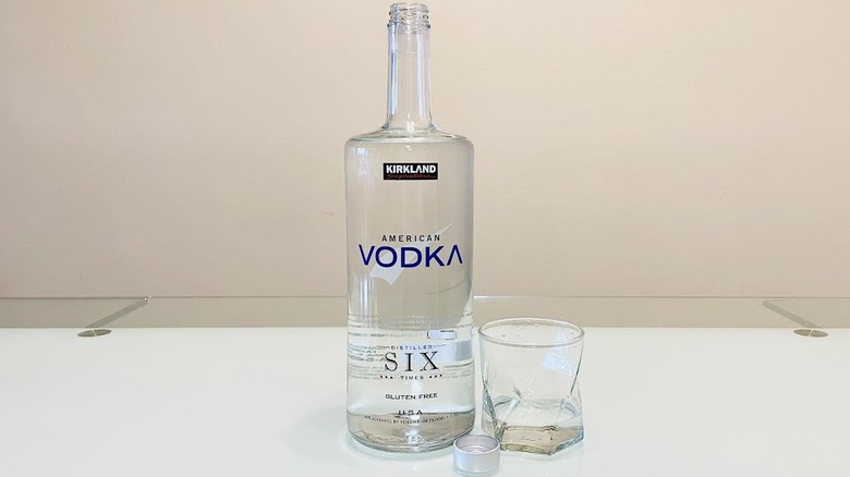 Bottle of Kirkland Signature American Vodka with glass on side