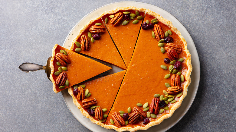 pumpkin pie with pecan garnish