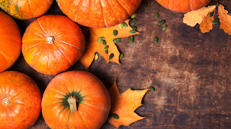 whole pumpkins on a wooden board