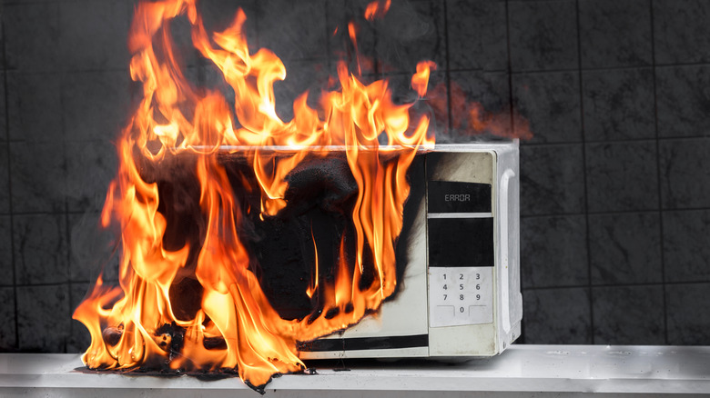 A microwave on fire displaying an error message