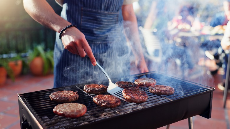 burgers sizzling on grill