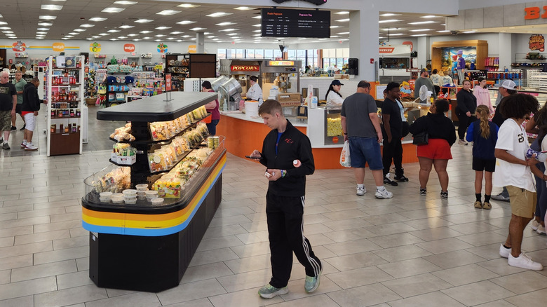 Customers walking around a large Wally's gas station convenience store