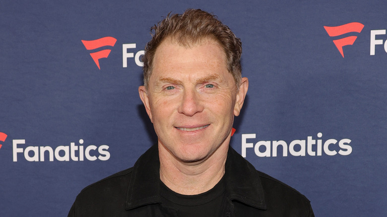 Bobby Flay smiling at a superbowl event