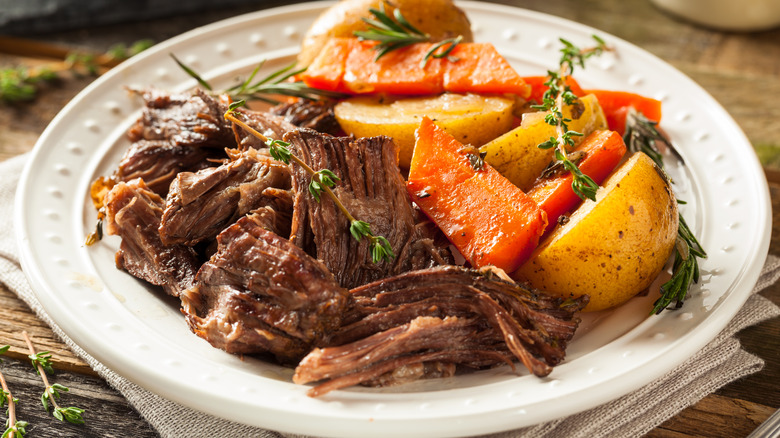 A plate of pot roast with hearty vegetables