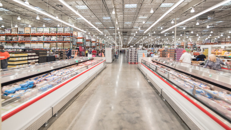 Bright lights beam ahead over the meat coolers in a Costco
