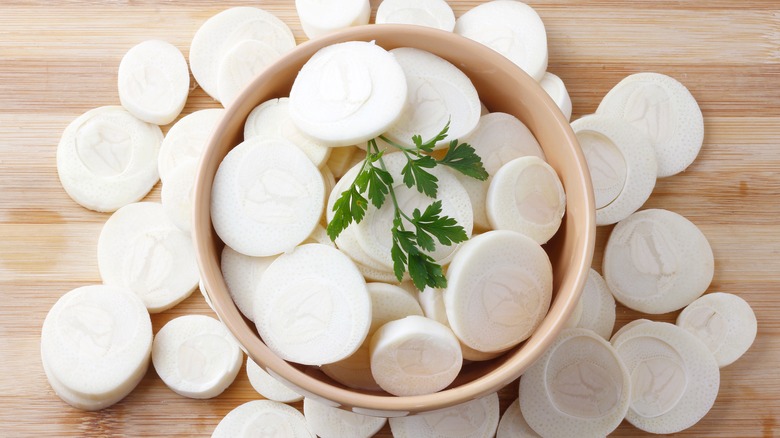 Sliced hearts of palm on a wooden background