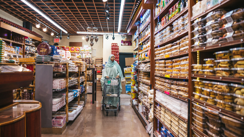 Woman walking through international aisle at World Market