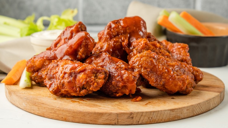 Buffalo chicken wings on wooden board