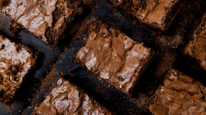Brownie squares on a black surface.
