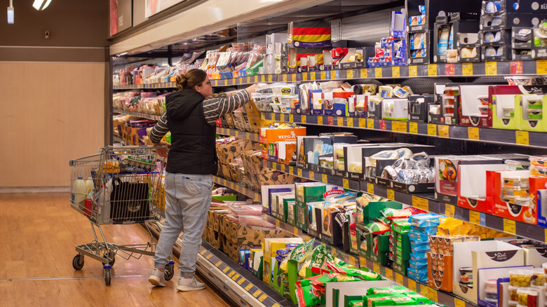Woman shopping in the dairy section of an Aldi