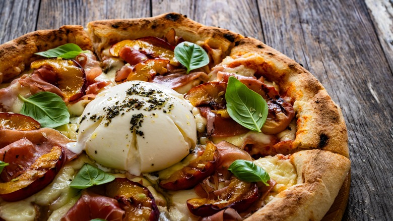 A burrata pizza topped with grilled peaches