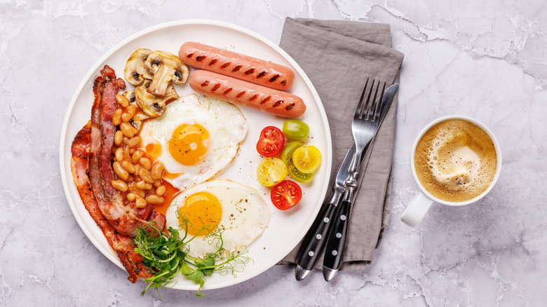 A full English breakfast with fried eggs and coffee