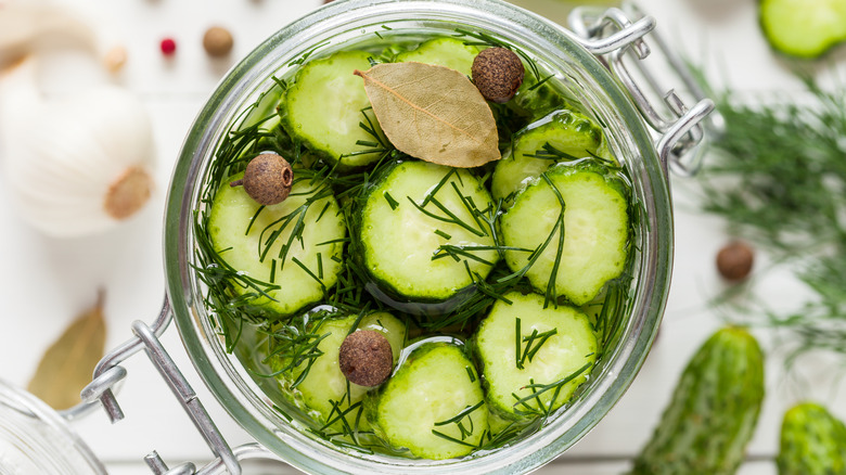 A close-up of a jar of homemade pickles from above