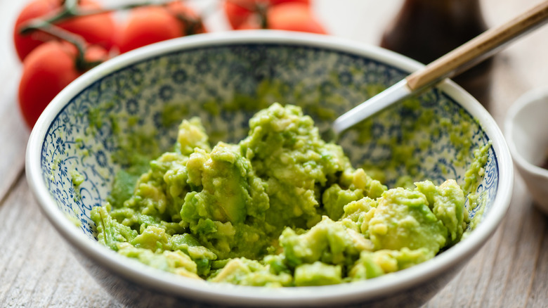 Hand squeezing avocado