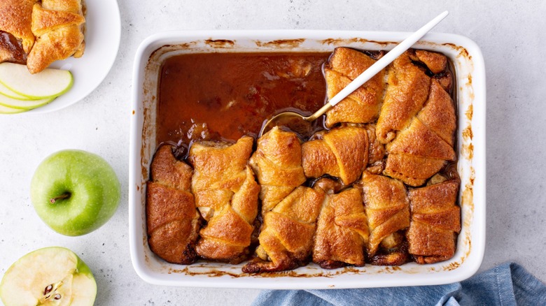 Baking dish filled with crescent roll apple dumplings