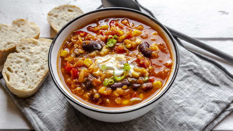 Bowl of chili with bread slices