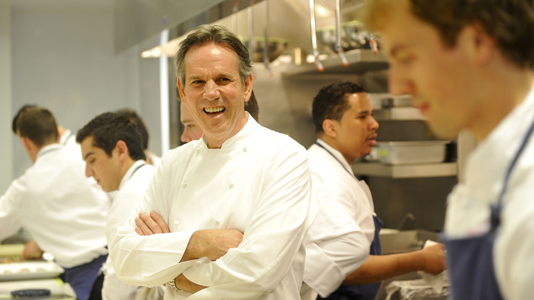 Thomas Keller laughes in the kitchen.