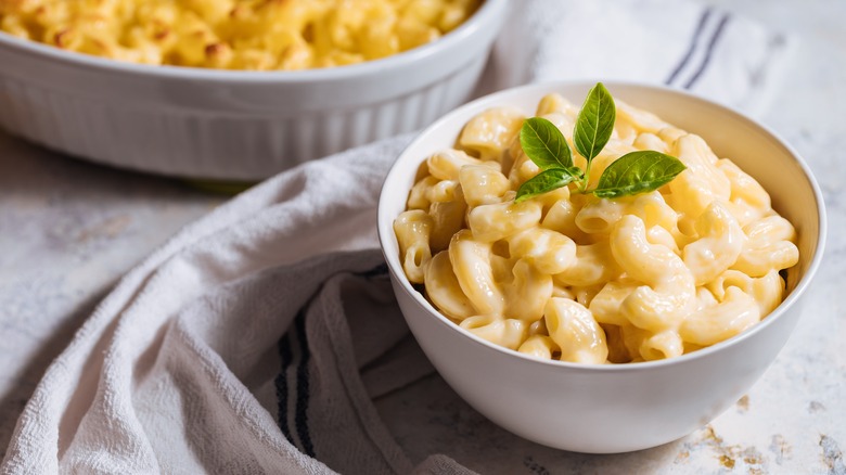 Bowl of creamy mac and cheese with garnish.
