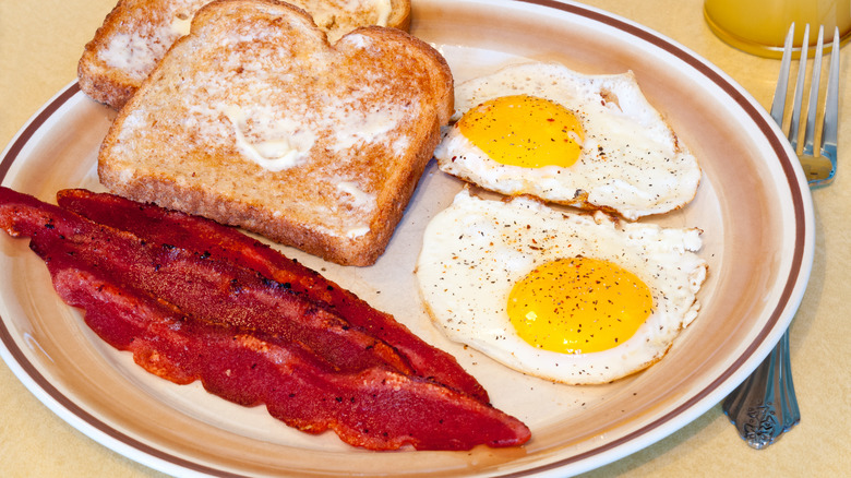 breakfast plate with eggs toast and turkey bacon