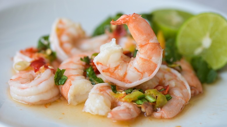 Shrimp and limes on plate