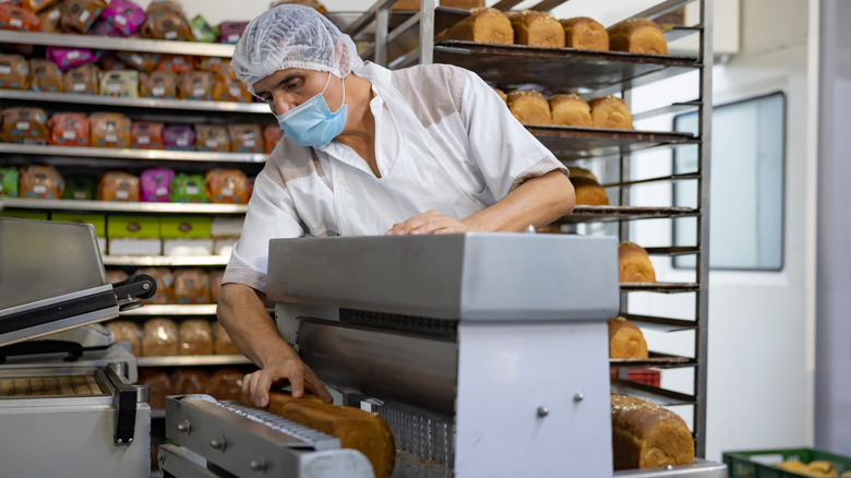 Slicing bread at bakery