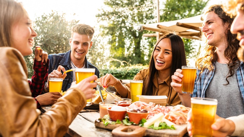 young people enjoying a meal outdoors together
