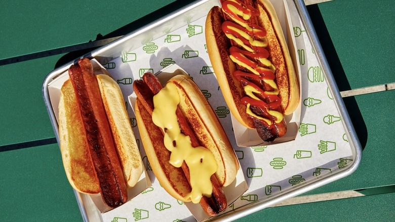 Three Shake Shack hot dogs on a tray