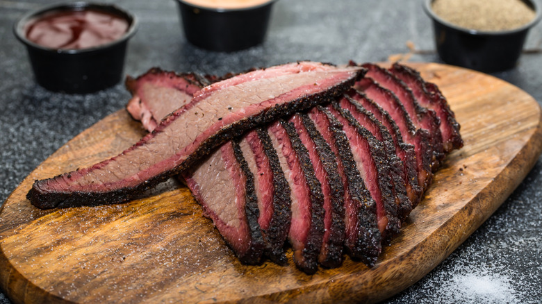 sliced brisket on wooden platter