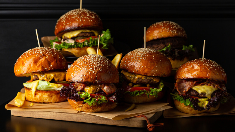 Variety of burgers on wooden trays