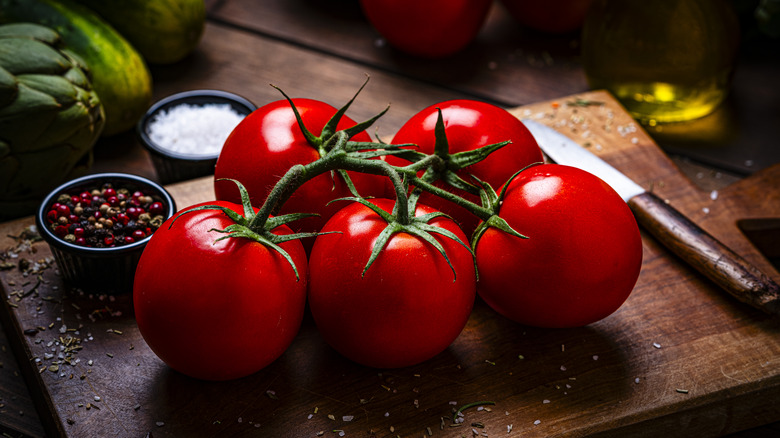 Whole tomatoes on a cutting board