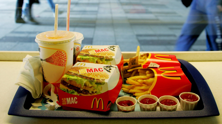 A McDonald's meal with two Big Macs, two fries, and two drinks sits on a tray overlooking a street in Stockholm, Sweden
