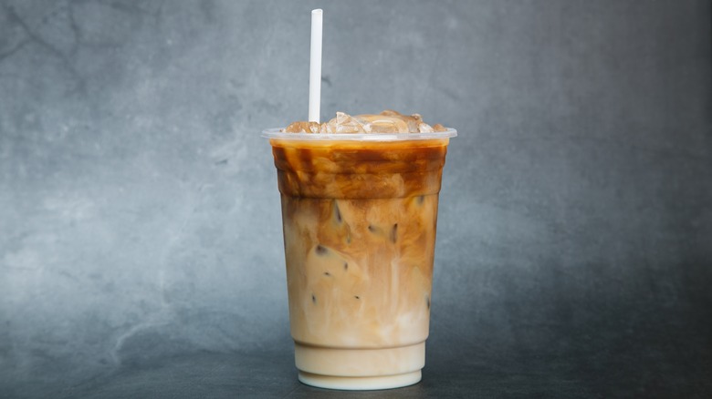 Iced coffee with cream and white straw