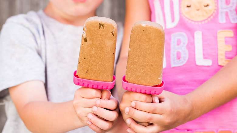 Children holding homemade pudding pops