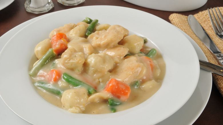stewed chicken and dumplings served in bowl