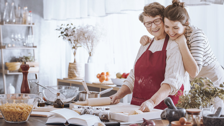 grandparent and grandchild cooking in kitchen