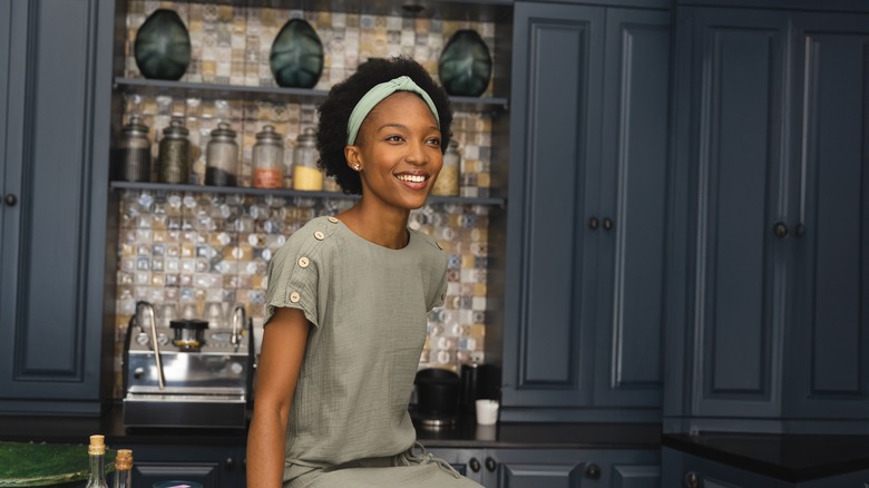 A homeowner sits in a nicely decorated kitchen
