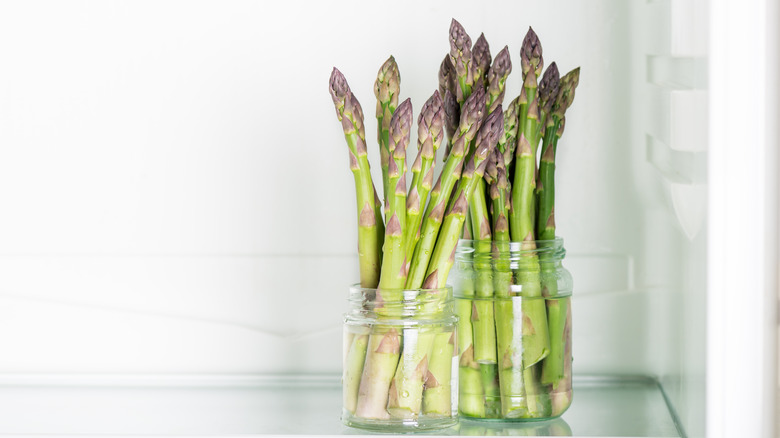asparagus in cups of water