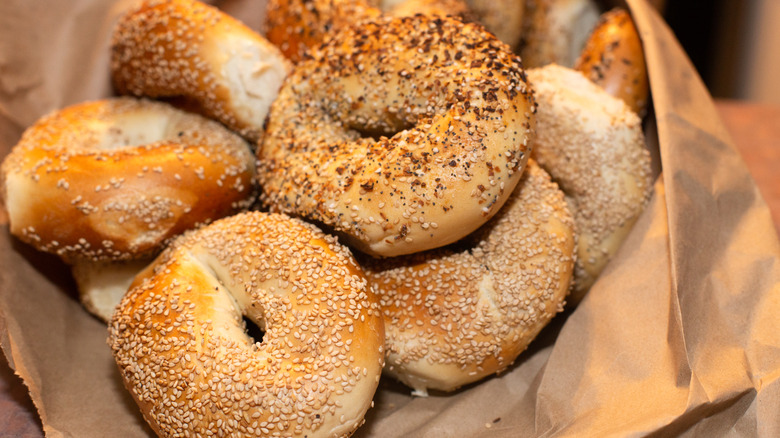 Assorted bagels in brown paper bag