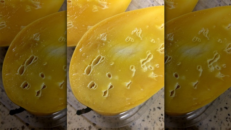 cut mango with white pockets