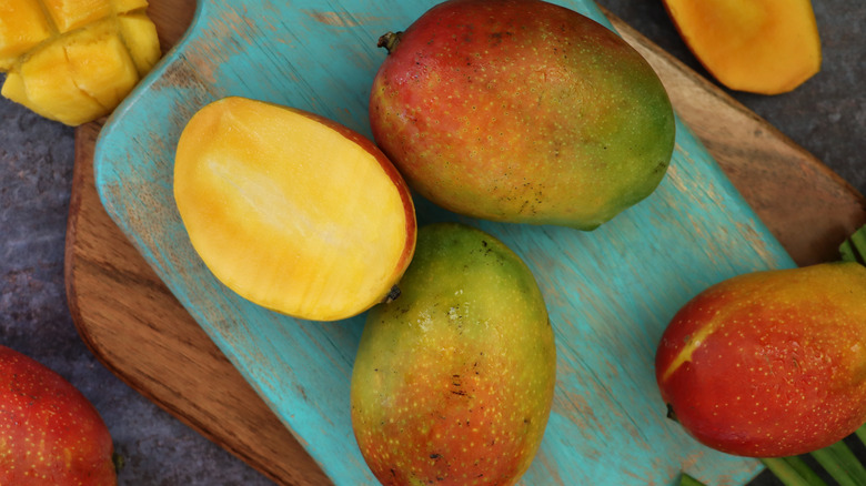 mangoes on wooden board