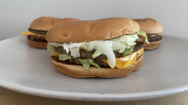 Several burgers from McDonald's on a white plate