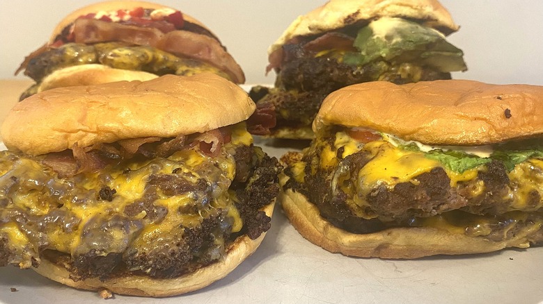 Various Shake Shack burgers on a white table